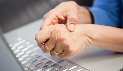 Laptop and woman with pain in hand